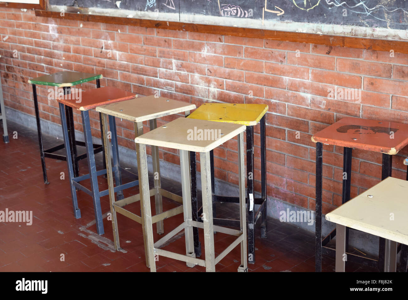 Old bar chairs in an art classroom. Tall chairs or stools. Stock Photo