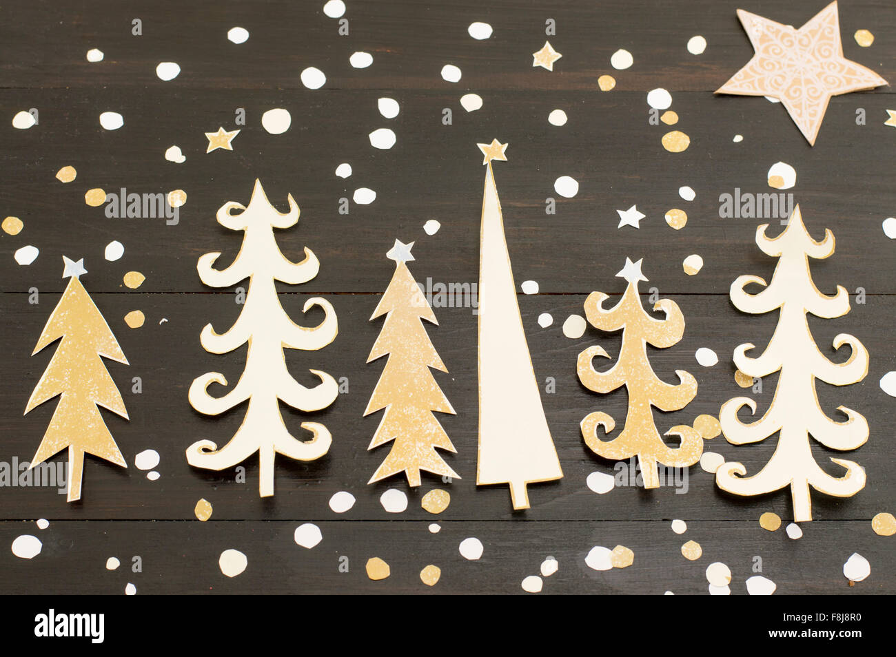 Christmas tree made out of paper with cut out star shapes Stock Photo