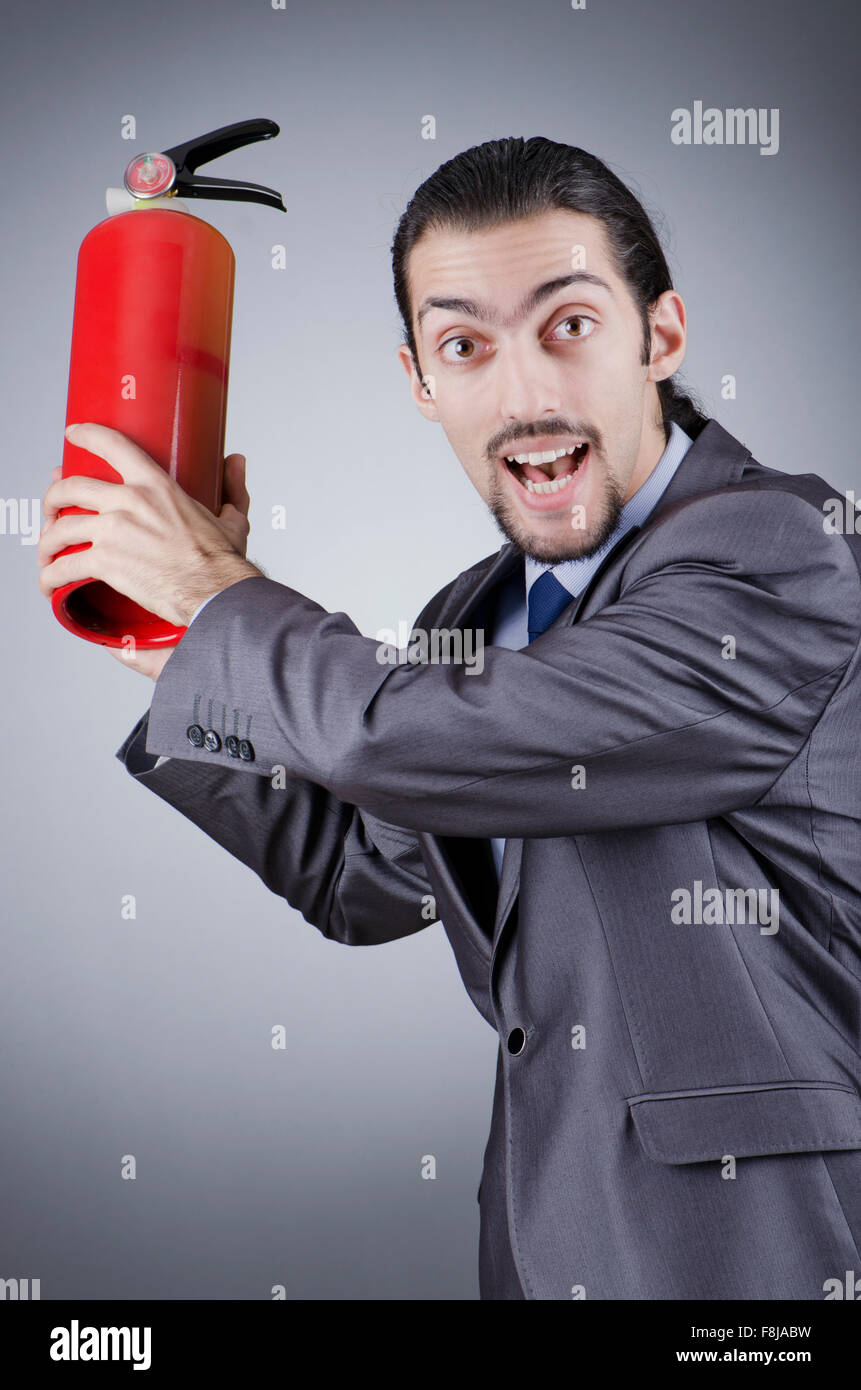 Man with fire extinguisher in firefighting concept Stock Photo Alamy
