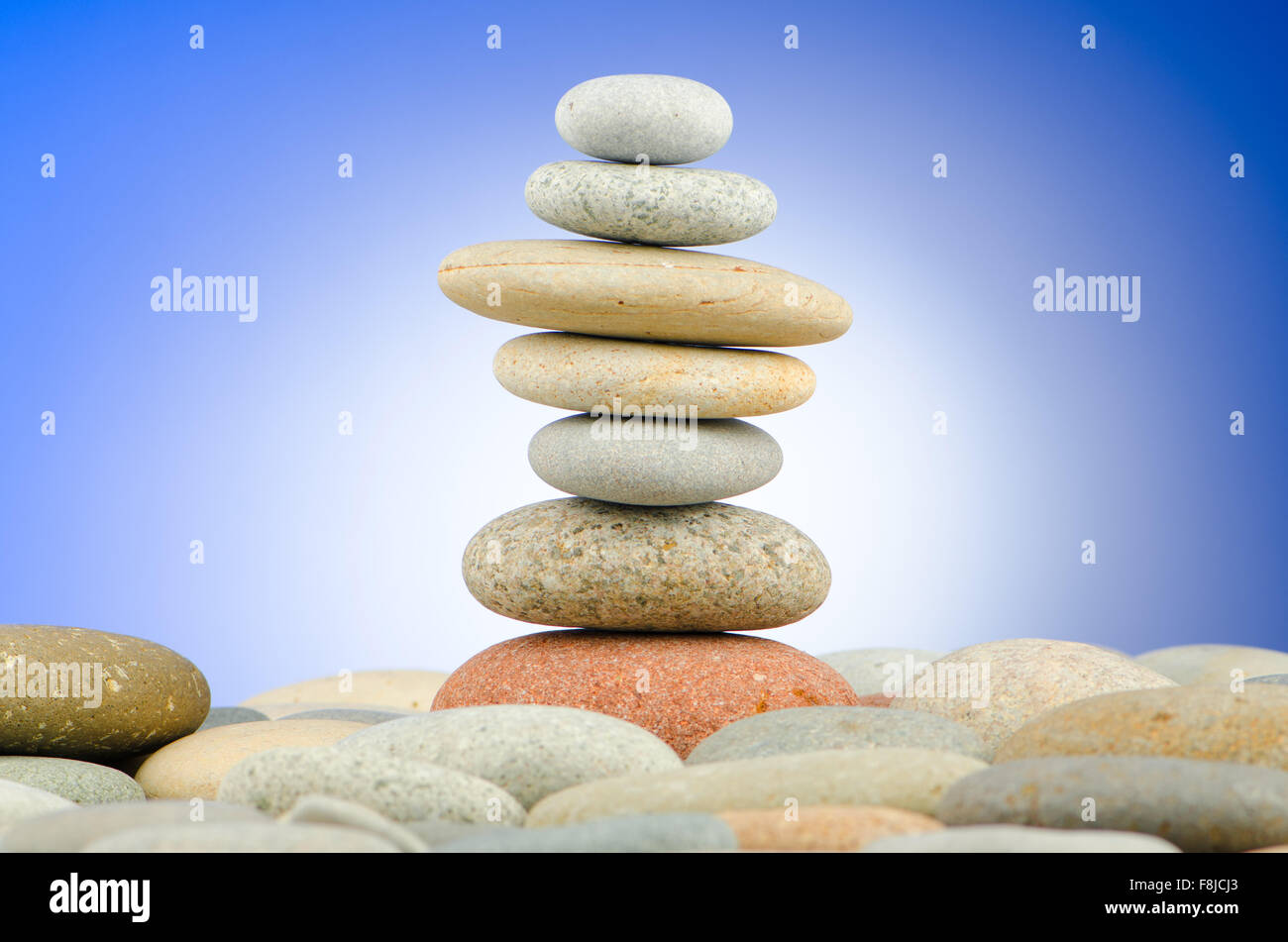 Pebbles stack against gradient background Stock Photo - Alamy
