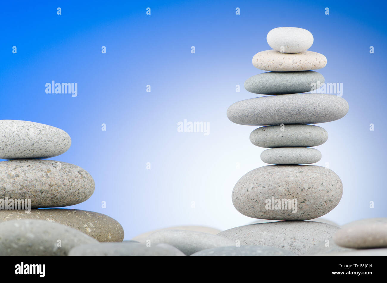 Pebbles stack against gradient background Stock Photo - Alamy
