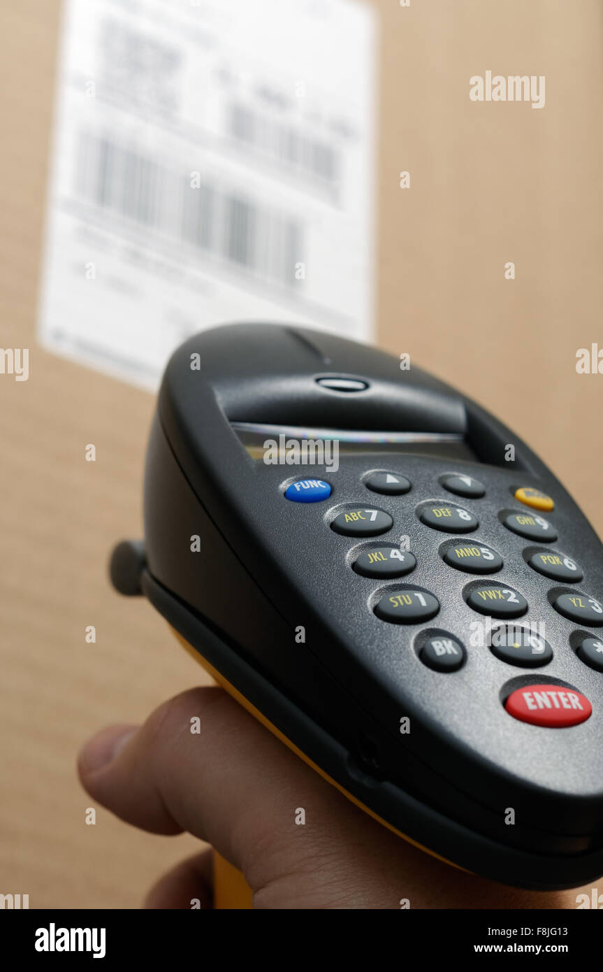 Barcode scanner reader with person's hand scanning a UPC bar code label ...