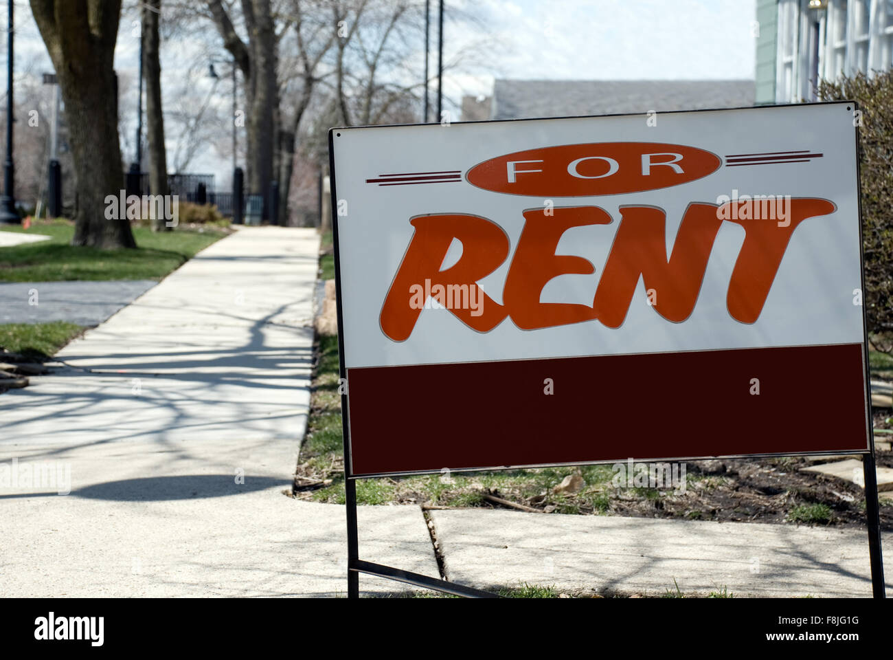 For Rent Sign. Picture of a for rent sign in front of a house in a suburban neighborhood Stock Photo