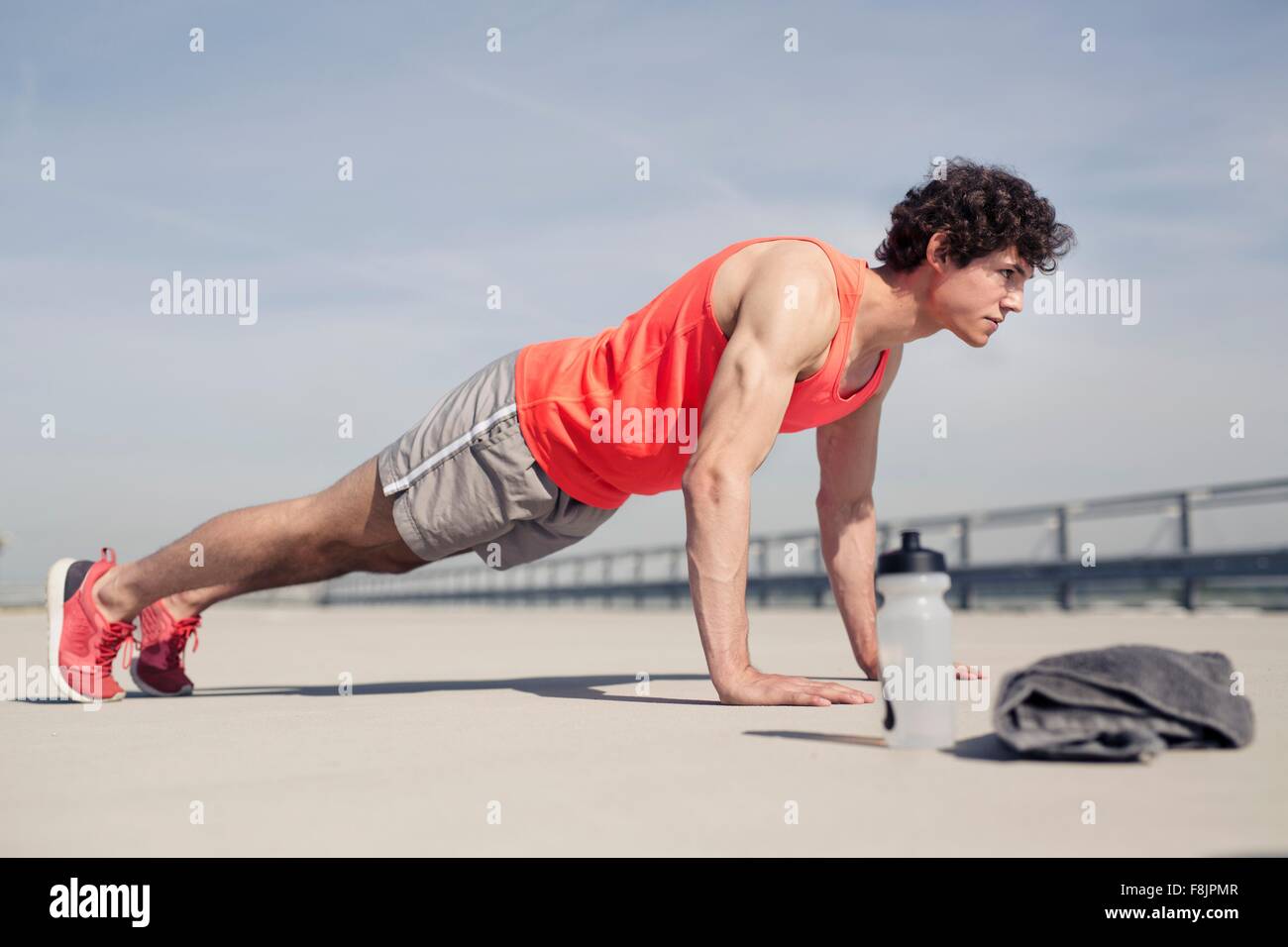 Young man training in city doing push ups Stock Photo - Alamy