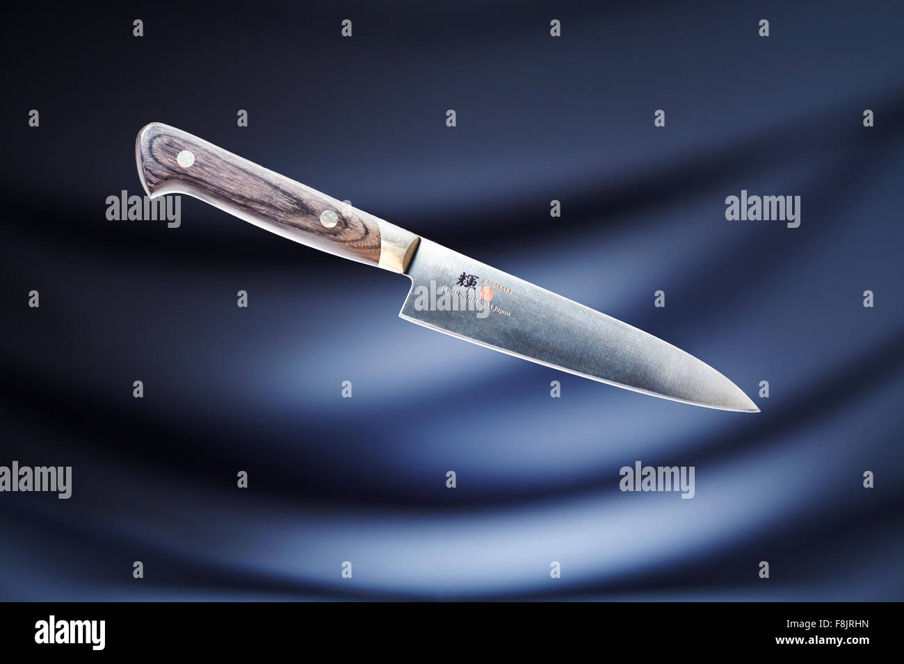 Knife against blue background Stock Photo