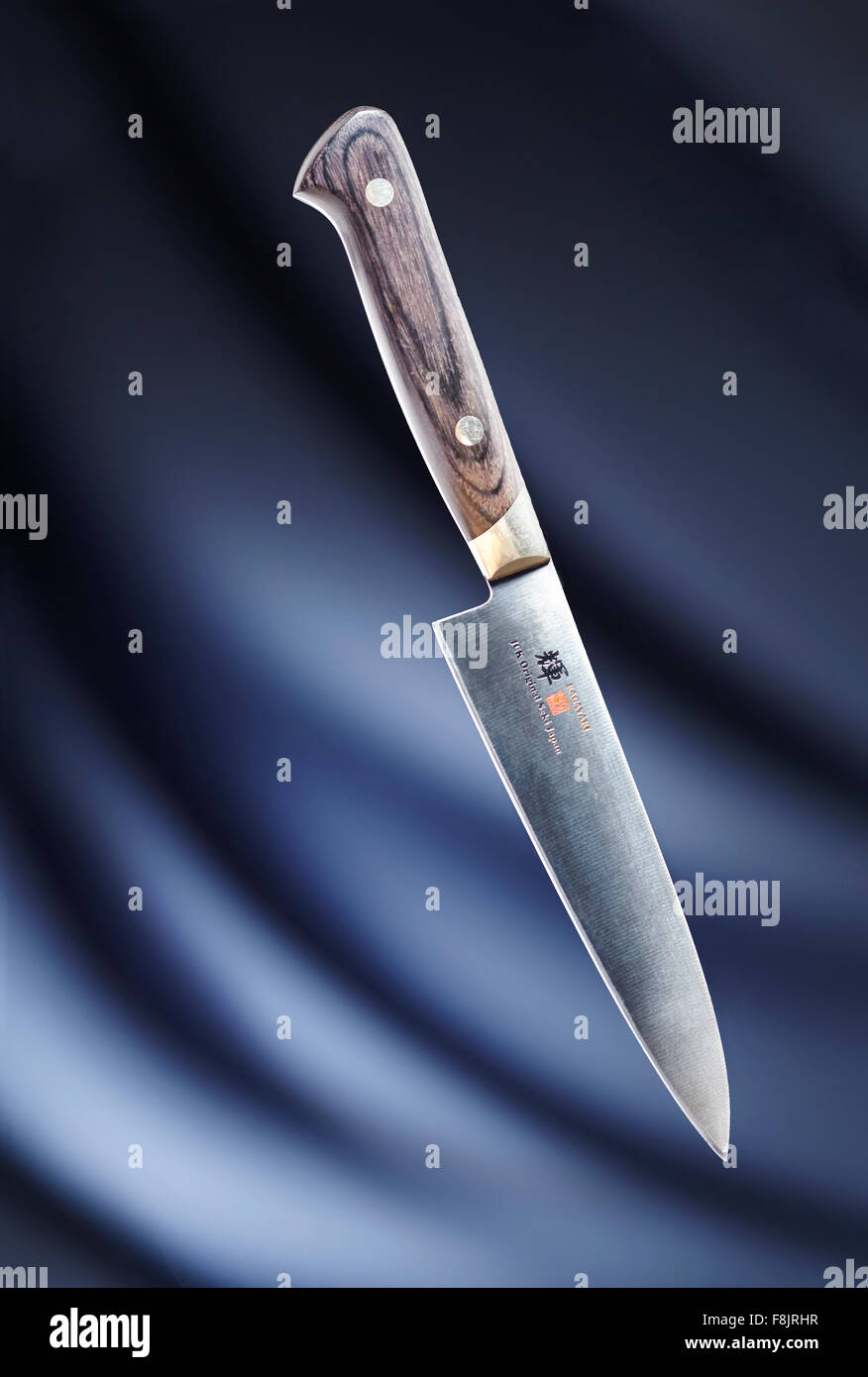 Knife against blue background Stock Photo