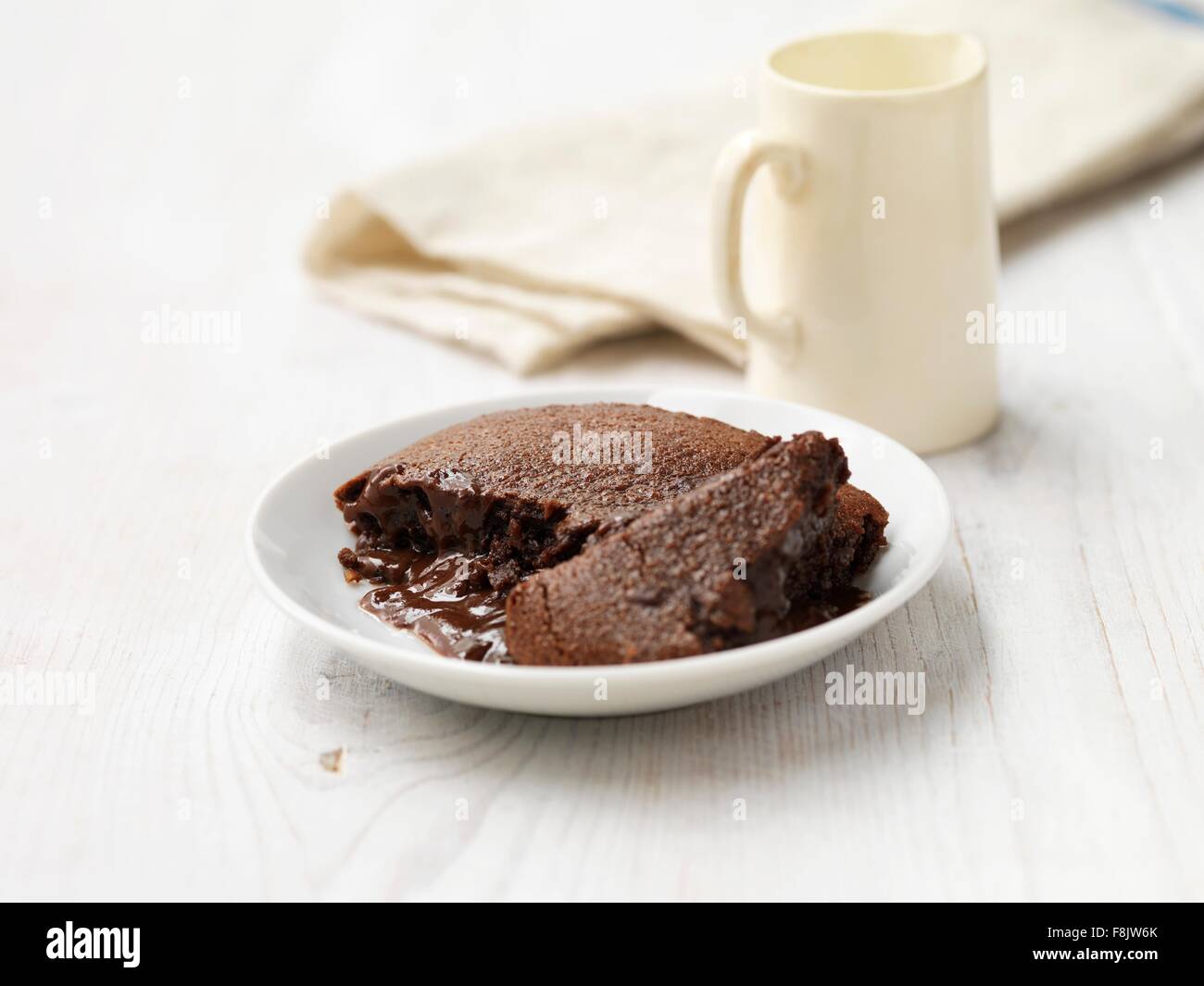 Hot chocolate fudge pudding on white washed wood Stock Photo Alamy