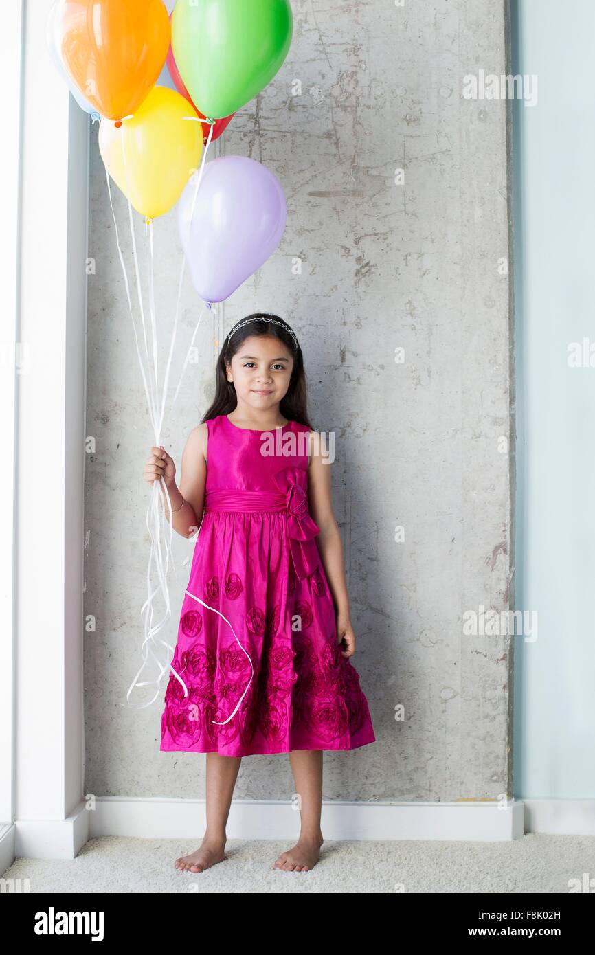 Portrait of young girl holding balloons Stock Photo Alamy