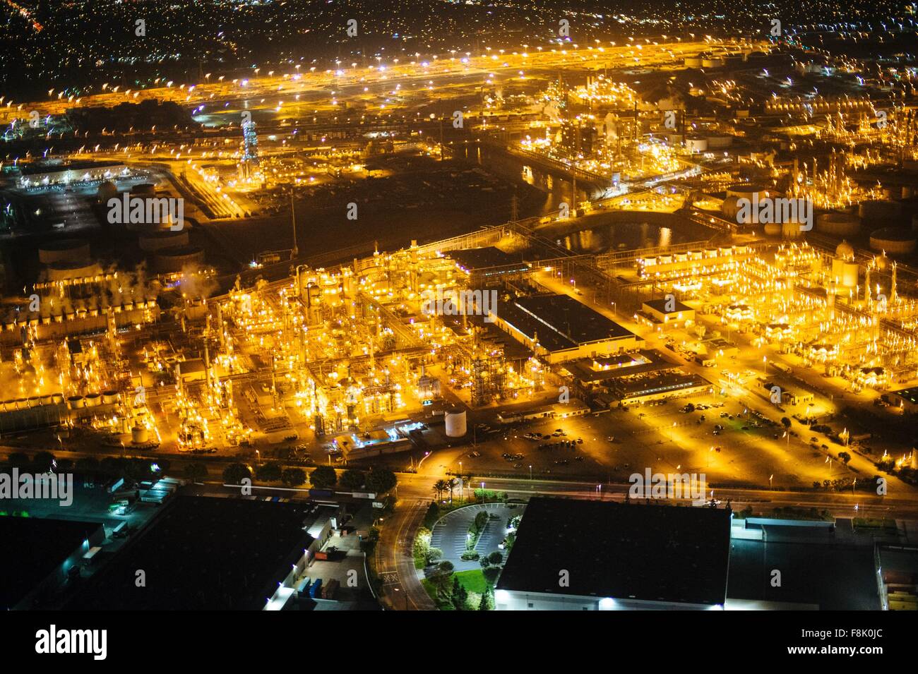 Aerial view of oil refinery illuminated at night, Los Angeles ...