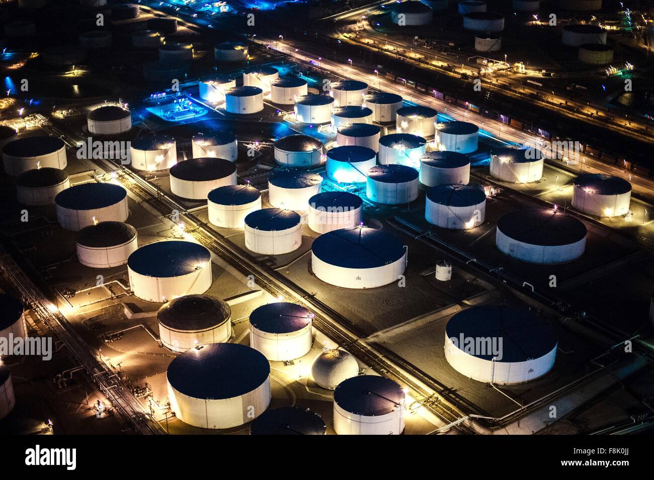 Aerial view of oil refinery storage tanks illuminated at night, Los ...