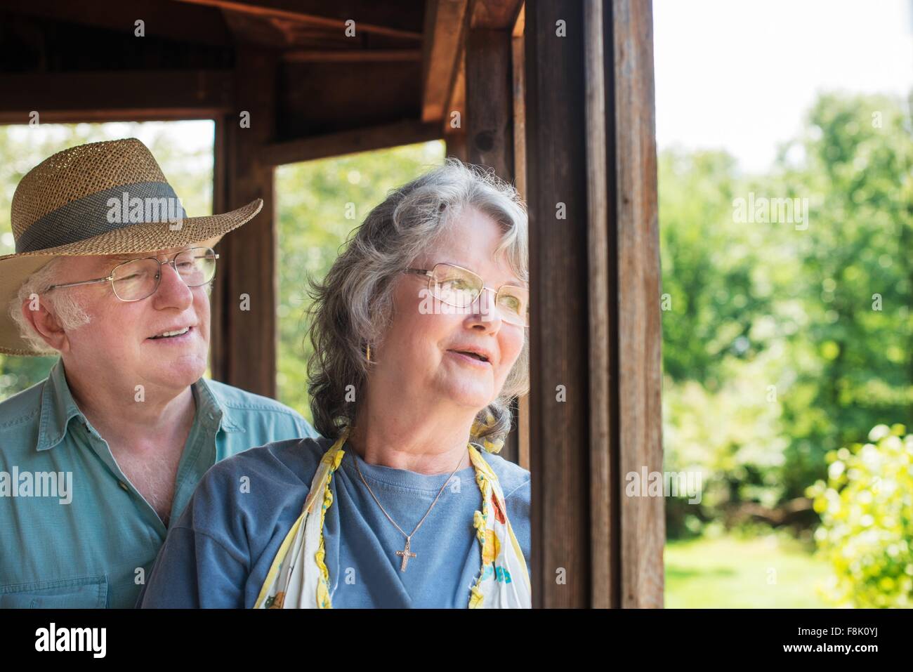 Portrait of senior couple looking out of window smiling Stock Photo