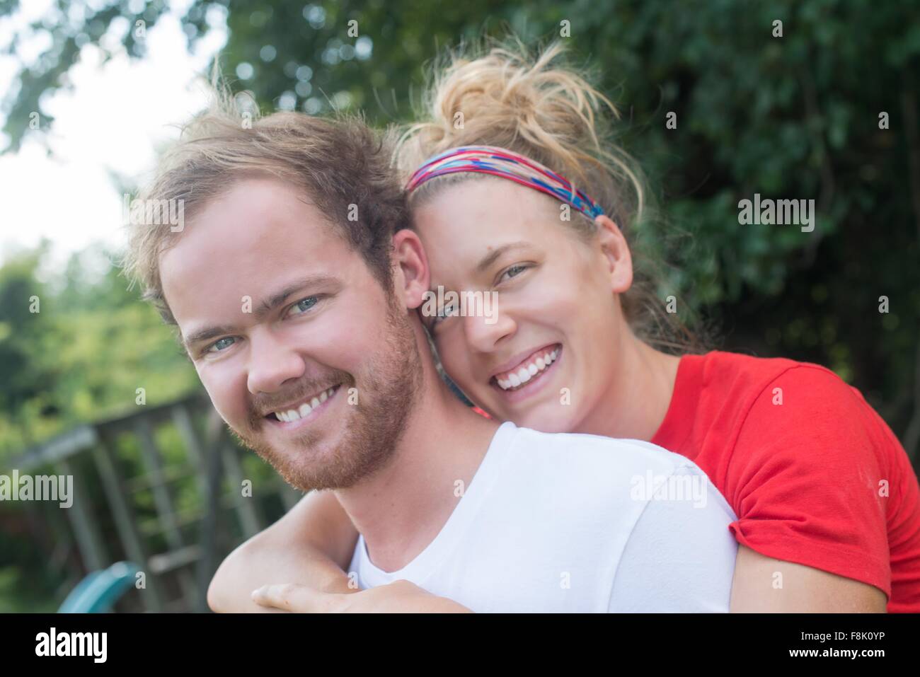 Portrait of couple hugging looking at camera smiling Stock Photo