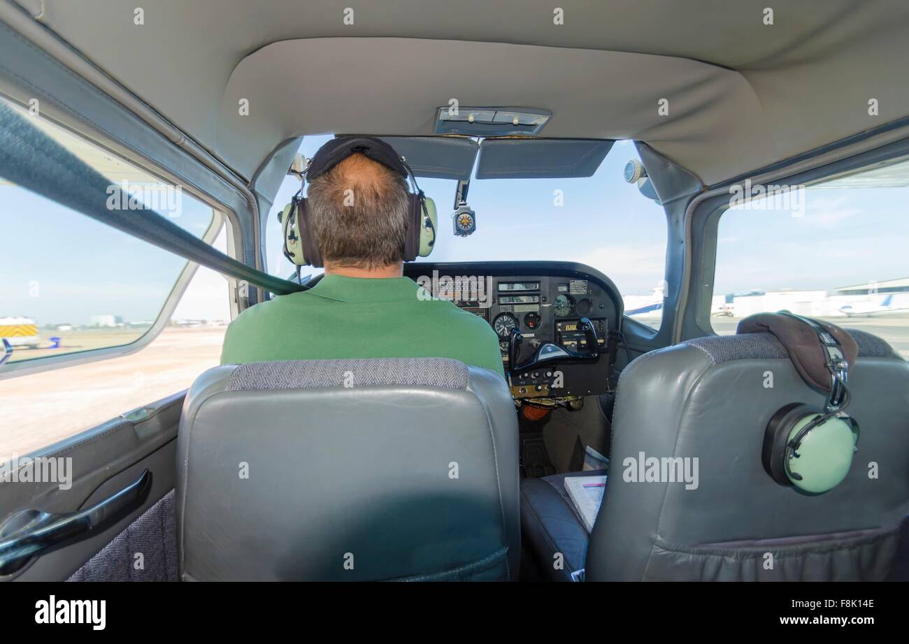 A rear view of a cessna pilot ready for take off. A small airplane with leather seats, with a passenger compartment and small co Stock Photo