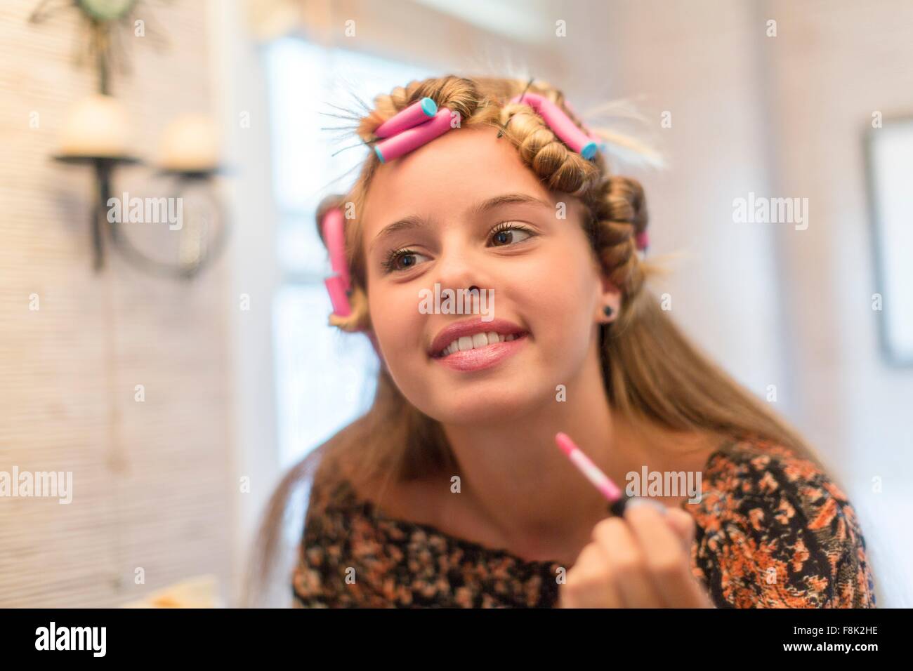 Teenager putting on make-up in bathroom Stock Photo