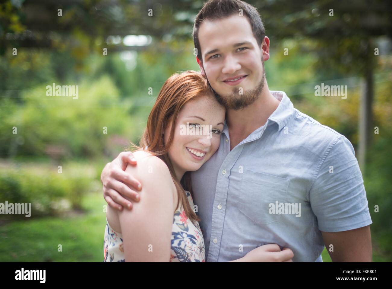 Portrait of couple hugging, looking at camera smiling Stock Photo