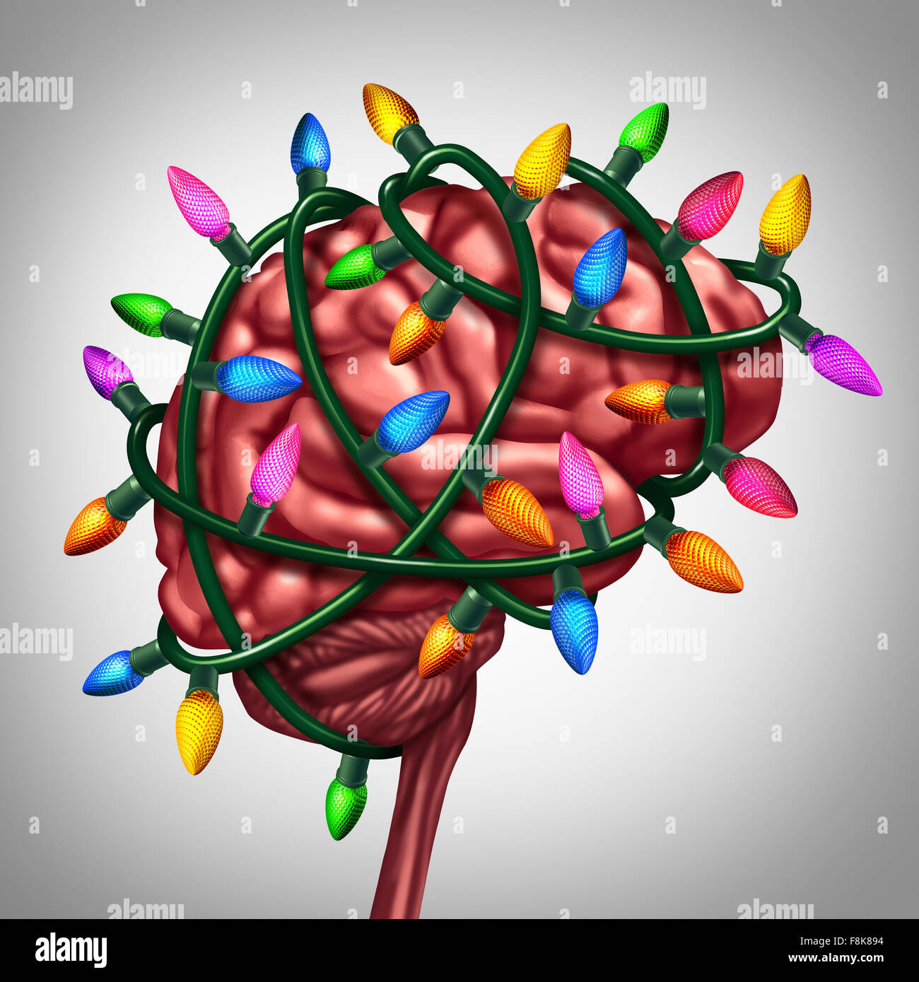 Holiday thinking and christmas memories concept as bright festive lights wrapped around a human brain as a metaphor for winter seasonal ideas as a new year and celebration symbol for decorating or gift giving inspiration. Stock Photo