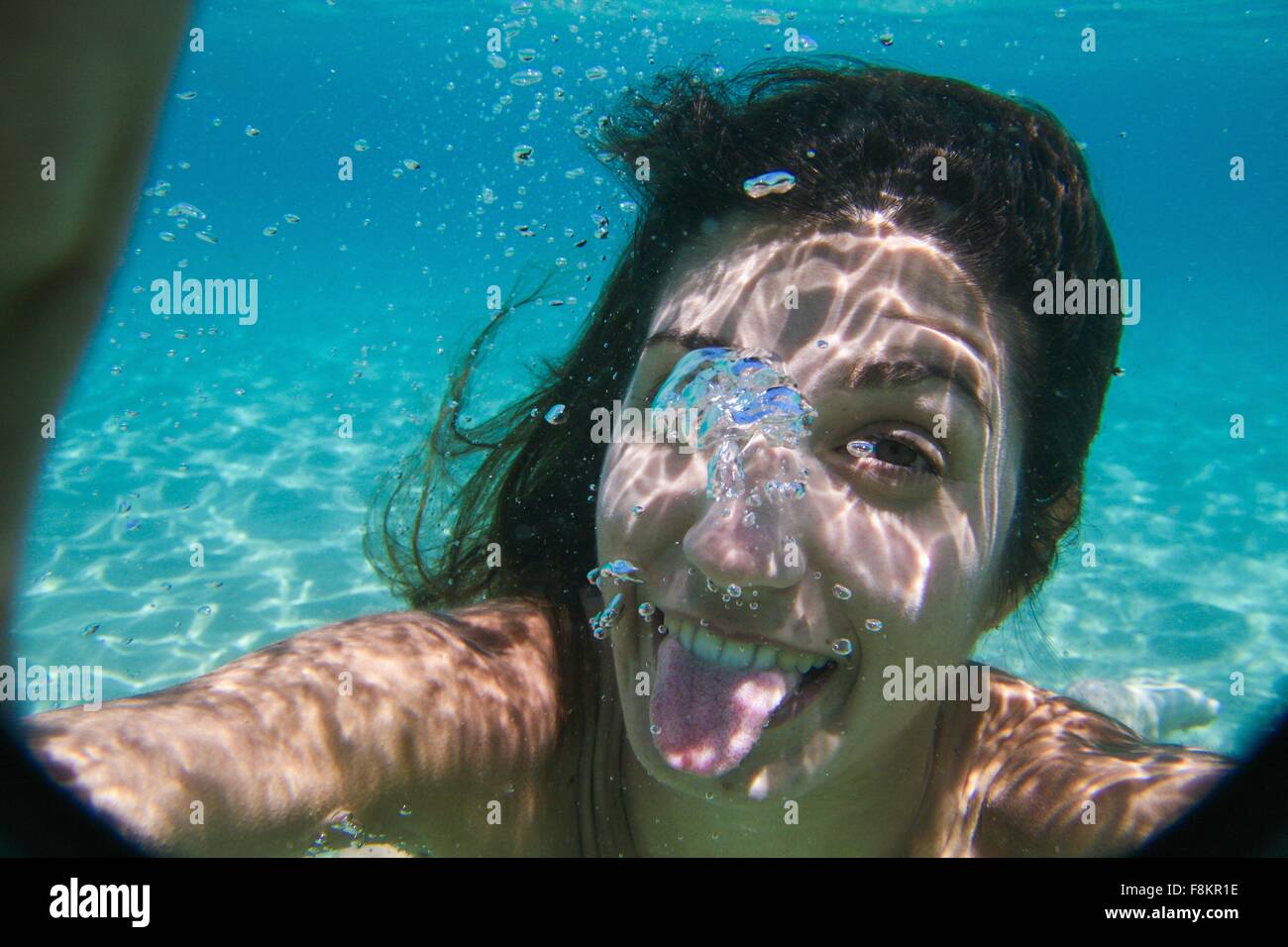 Young woman swimming underwater in ocean Stock Photo - Alamy