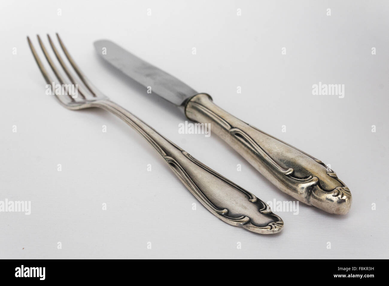 knife, fork - beautiful old  silver cutlery set on white background, copy space Stock Photo