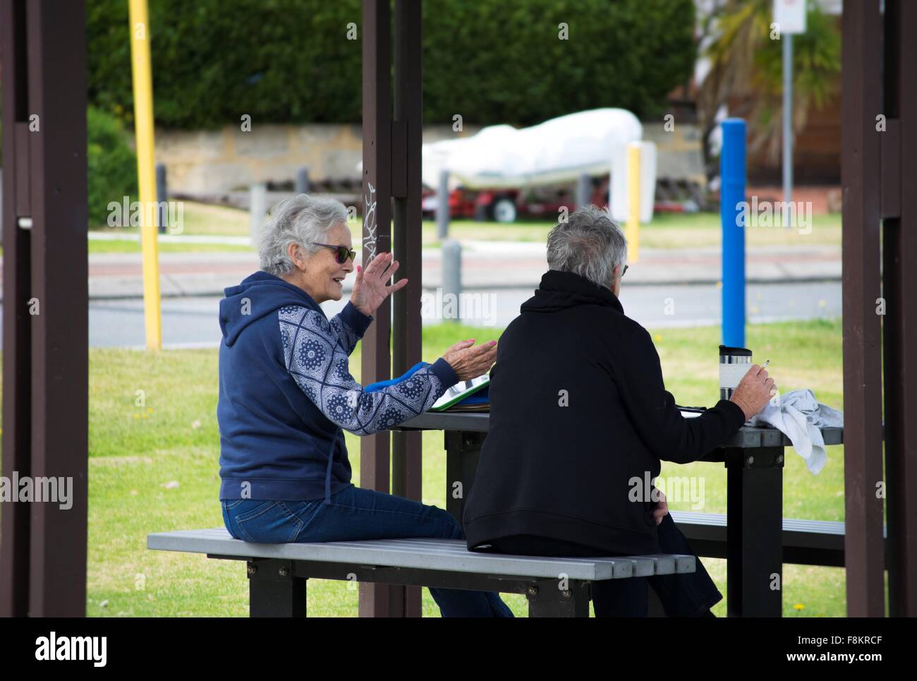 two elderly ladies chatting on a bright, sunny morning Stock Photo