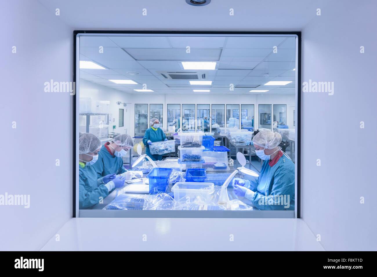 Workers inspecting surgical instruments in clean room of surgical instruments factory Stock