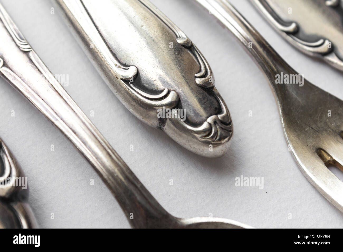 old sterling cutlery macro,  fancy flatware closeup on white background Stock Photo