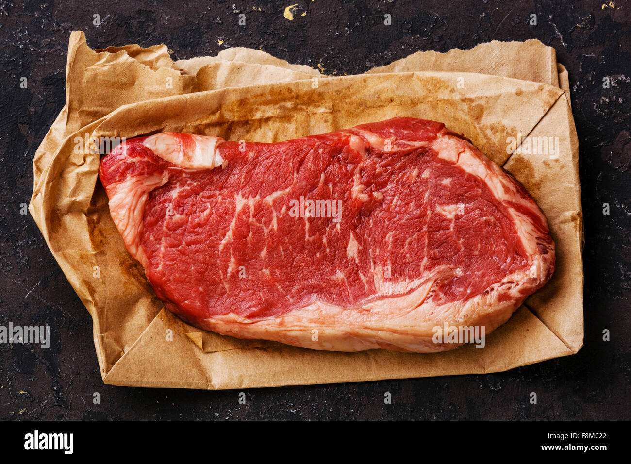 Raw fresh meat Striploin steak on kraft paper background Stock Photo
