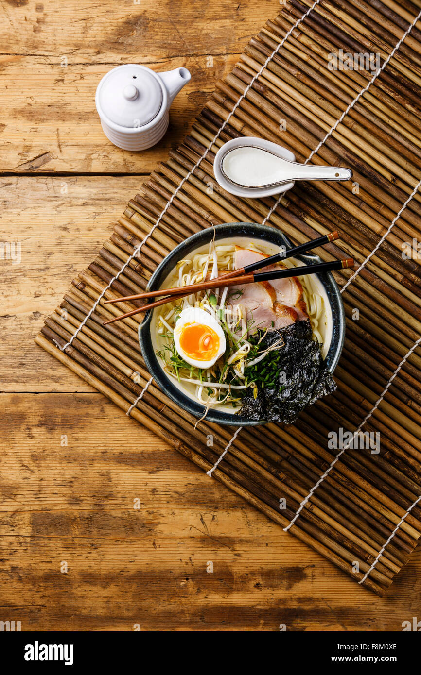 Udon noodle with boiled pork, wheat germ and egg on wooden background Stock Photo