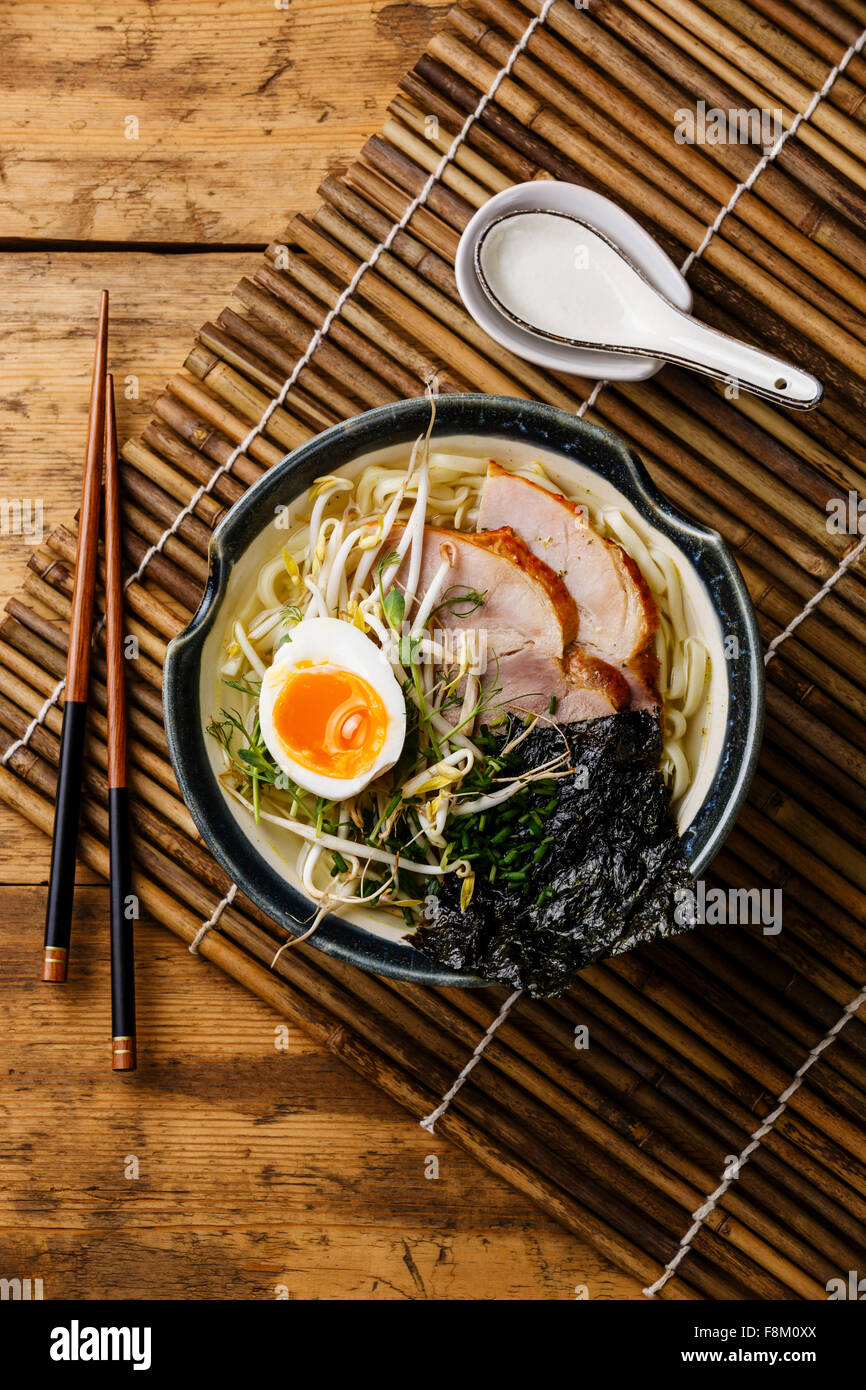 Udon noodle with boiled pork, wheat germ and egg on wooden background Stock Photo