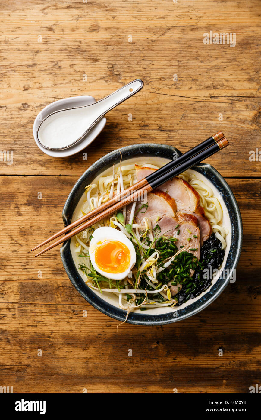 Udon noodle with boiled pork, wheat germ and egg on wooden background Stock Photo