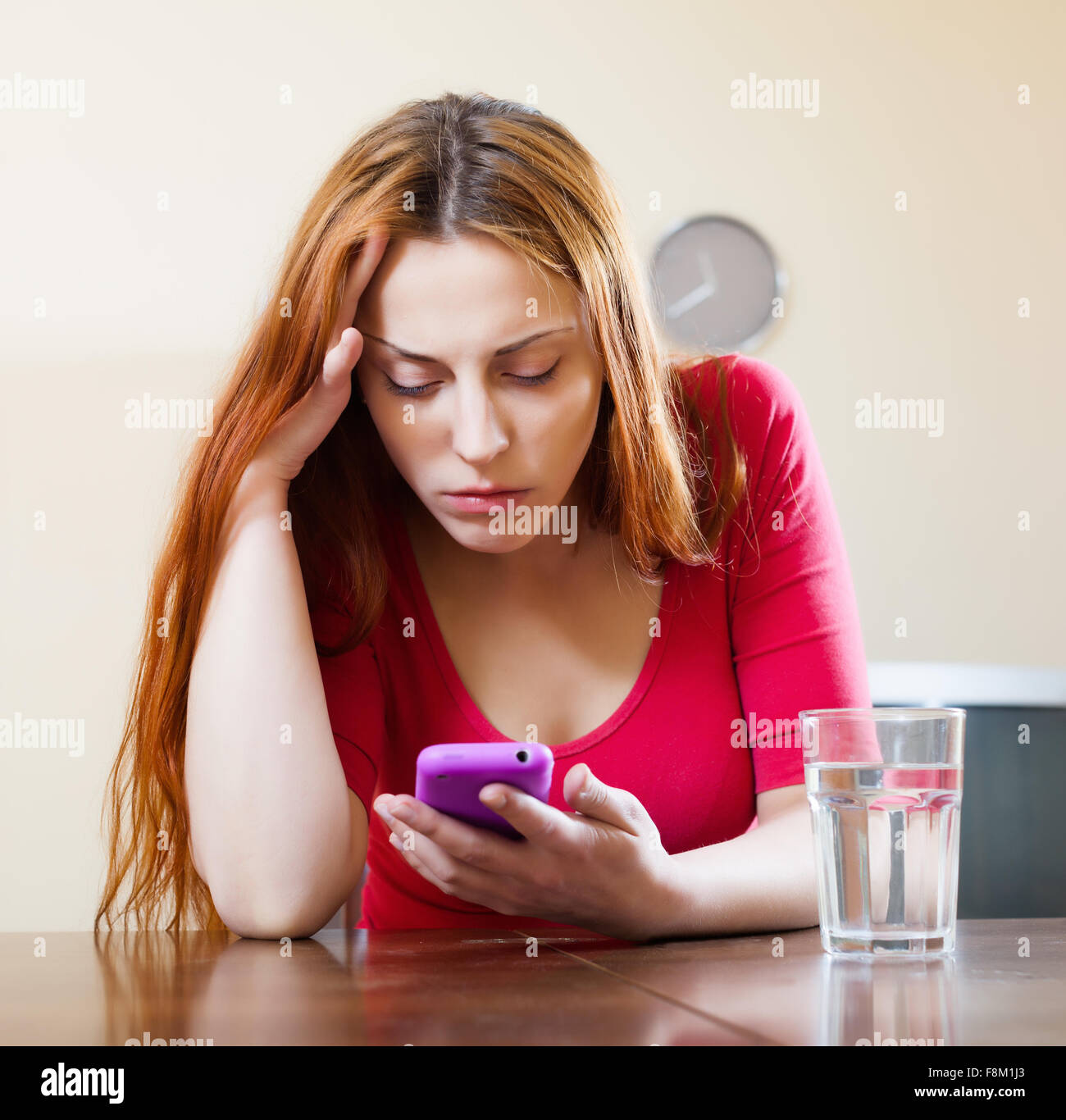 Woman crying after phone call at home Stock Photo - Alamy
