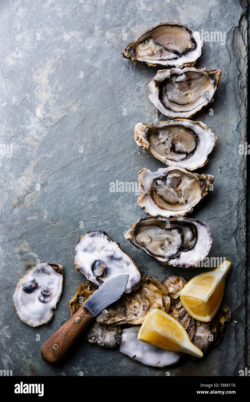 Open Oysters Fines de Claire on stone plate with lemon Stock Photo Alamy