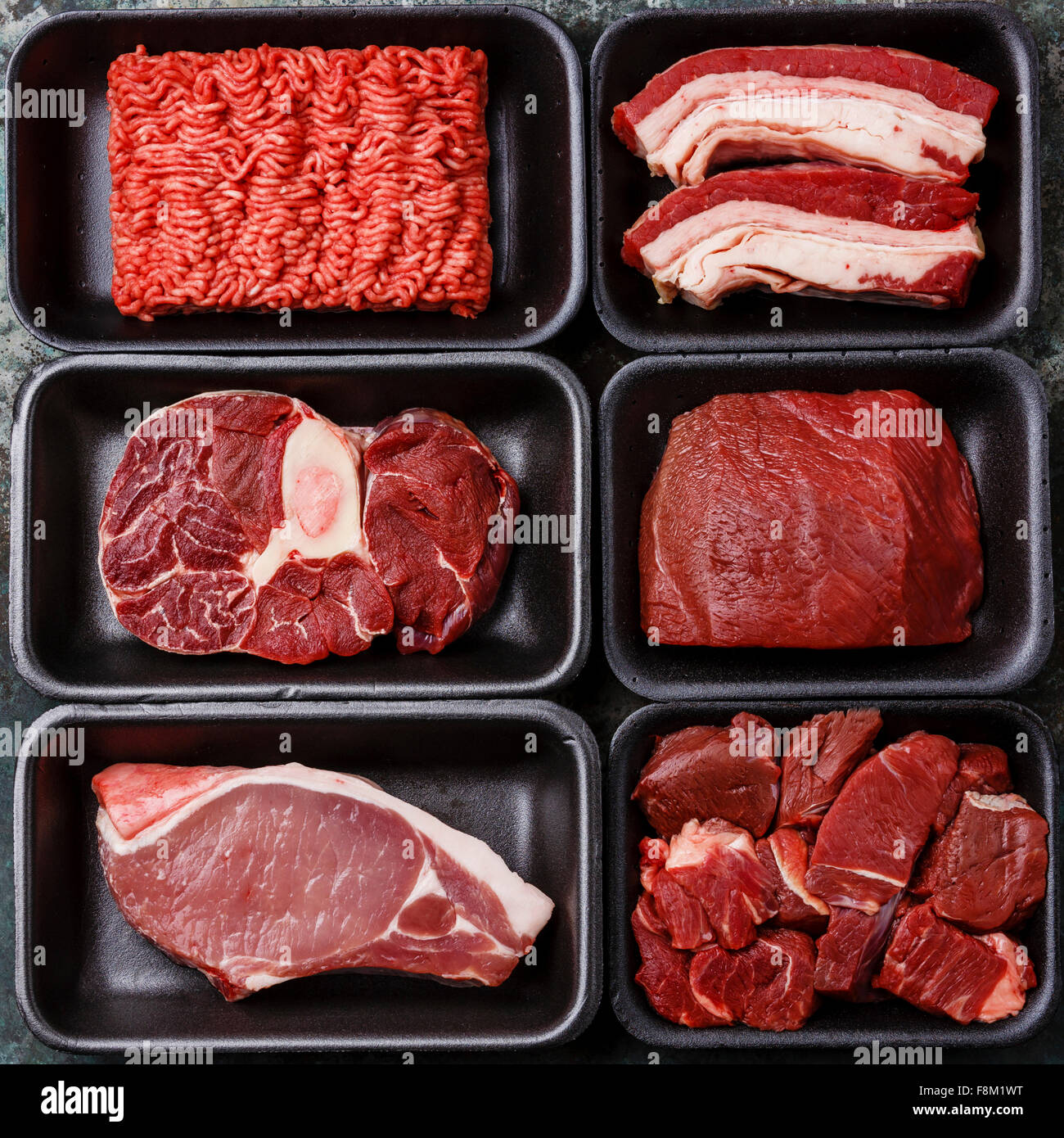 Different types of meat in plastic boxes packaging tray Stock Photo