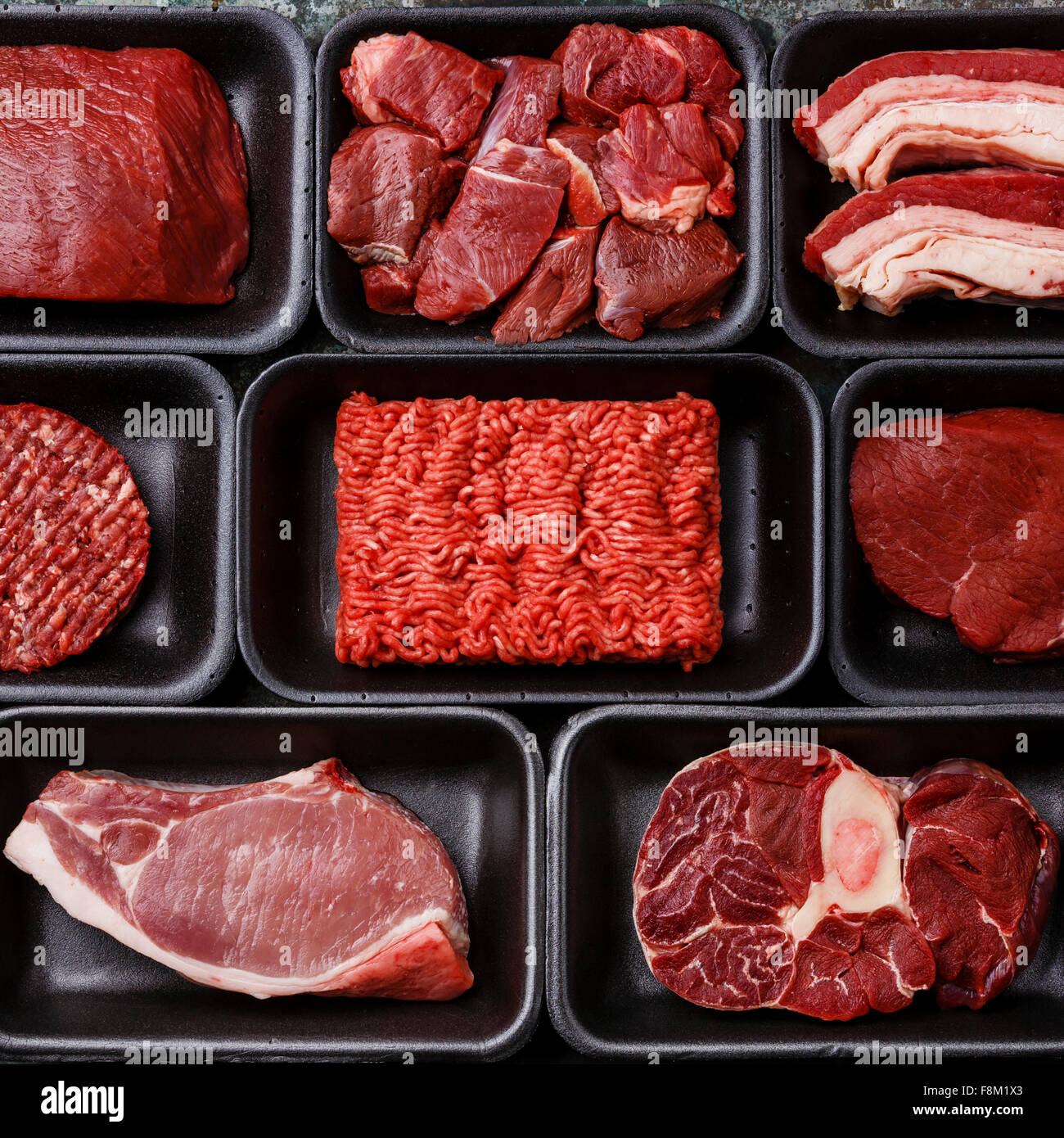 Different types of meat in plastic boxes packaging tray Stock Photo