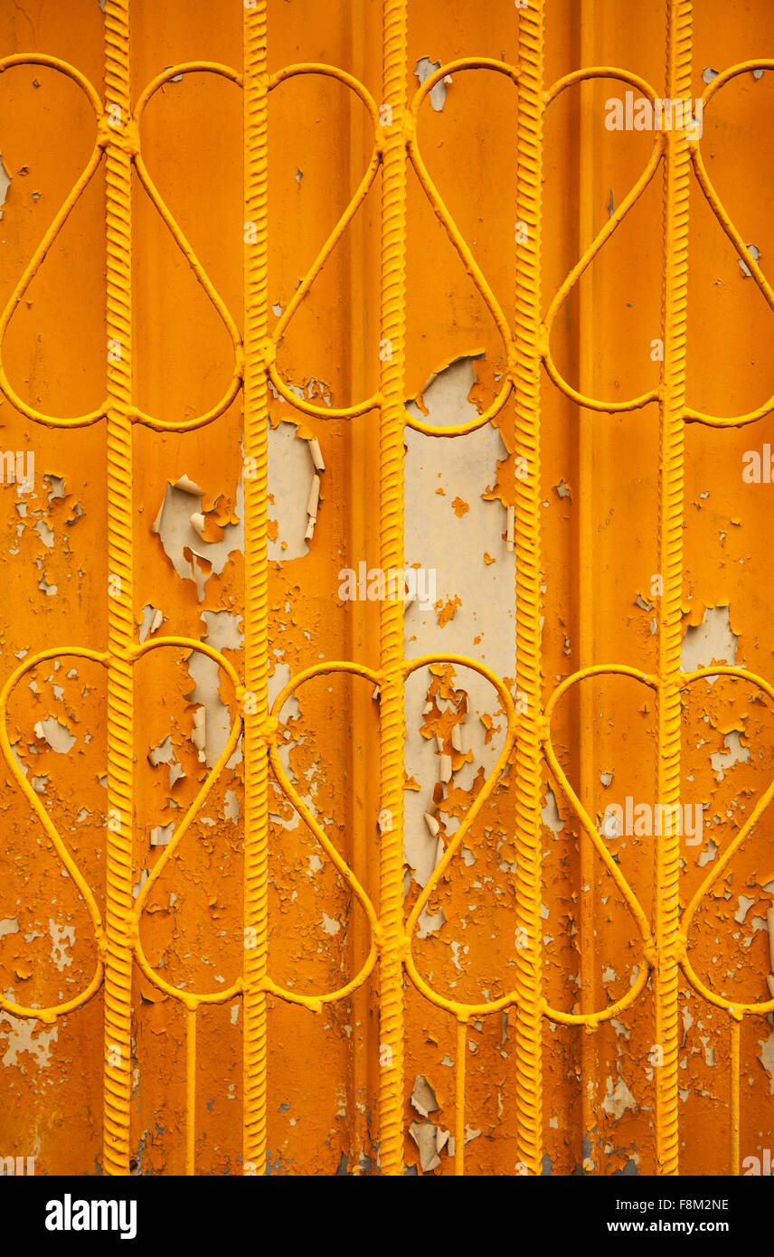Rod metal orange fence surface abstract, decorative old fence with hearts like shaped wires and weathered paint texture... Stock Photo