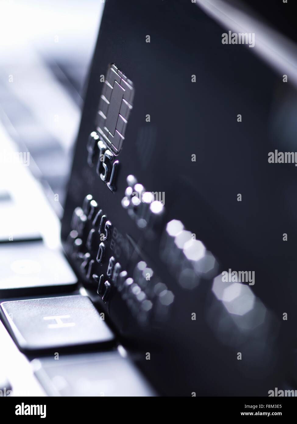 Close up of black credit card standing on computer keyboard Stock Photo