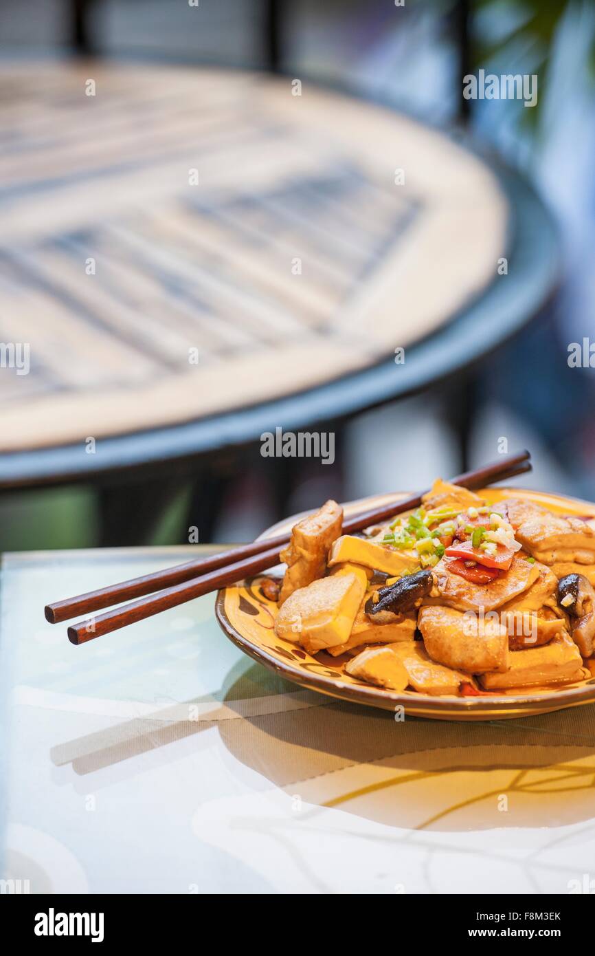 High angle view of Chinese tofu in bowl with chop sticks Stock Photo