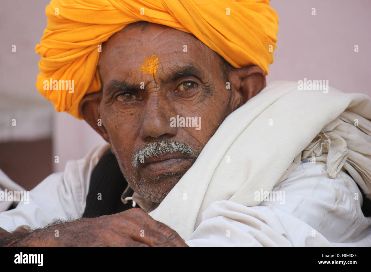 Pushkar, India, November 28, 2012: Senior Indian Man with orange turban Stock Photo