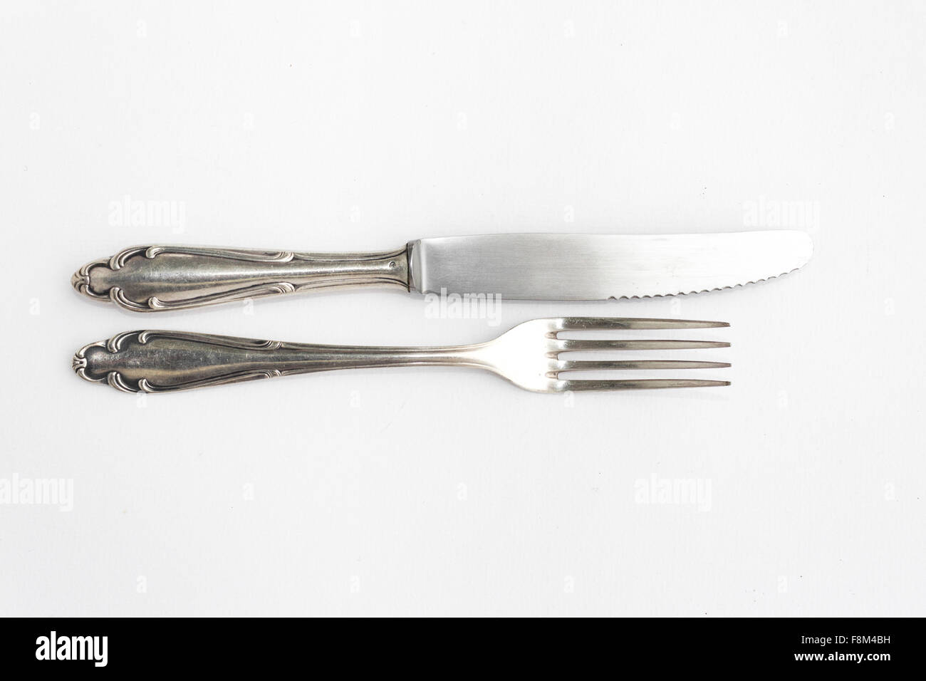 knife, fork - beautiful old  silver cutlery set on white background, copy space Stock Photo