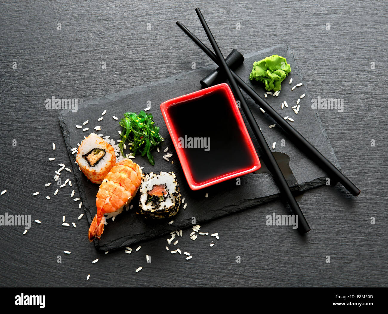 Delicious sushi with soy sauce on slate Stock Photo