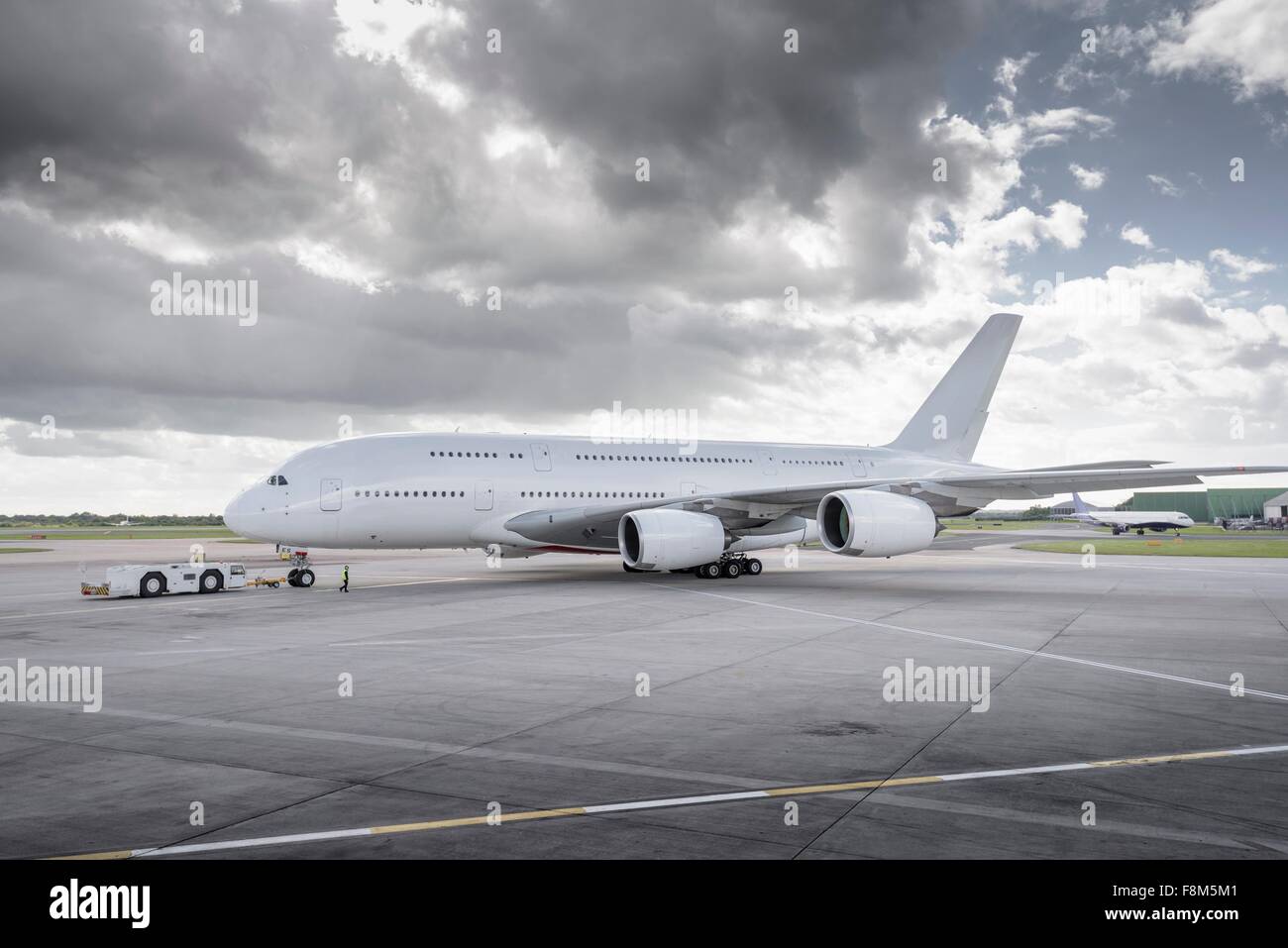 Towing tug moving A380 aircraft onto runway Stock Photo
