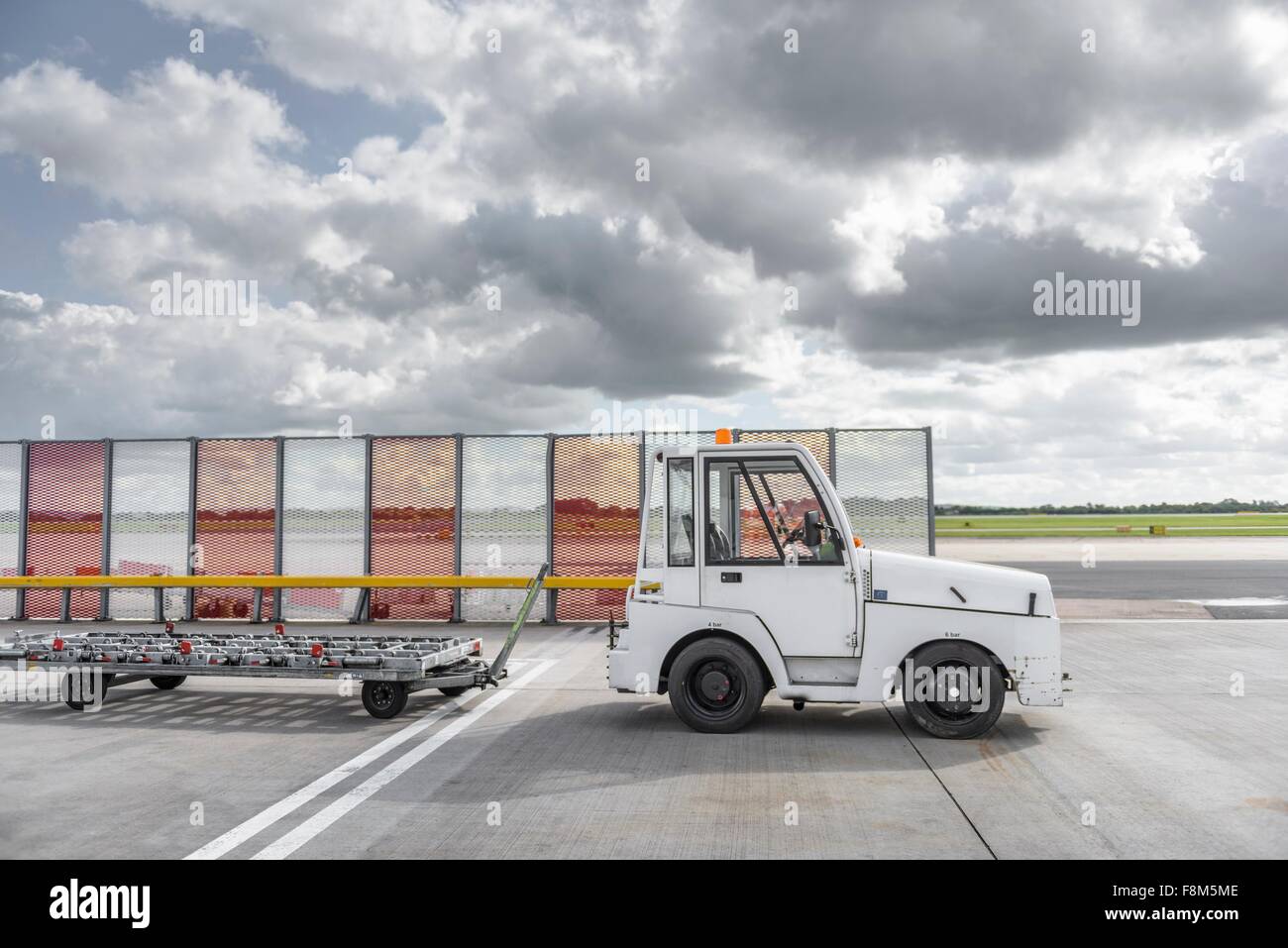 Small baggage handling tug at airport Stock Photo