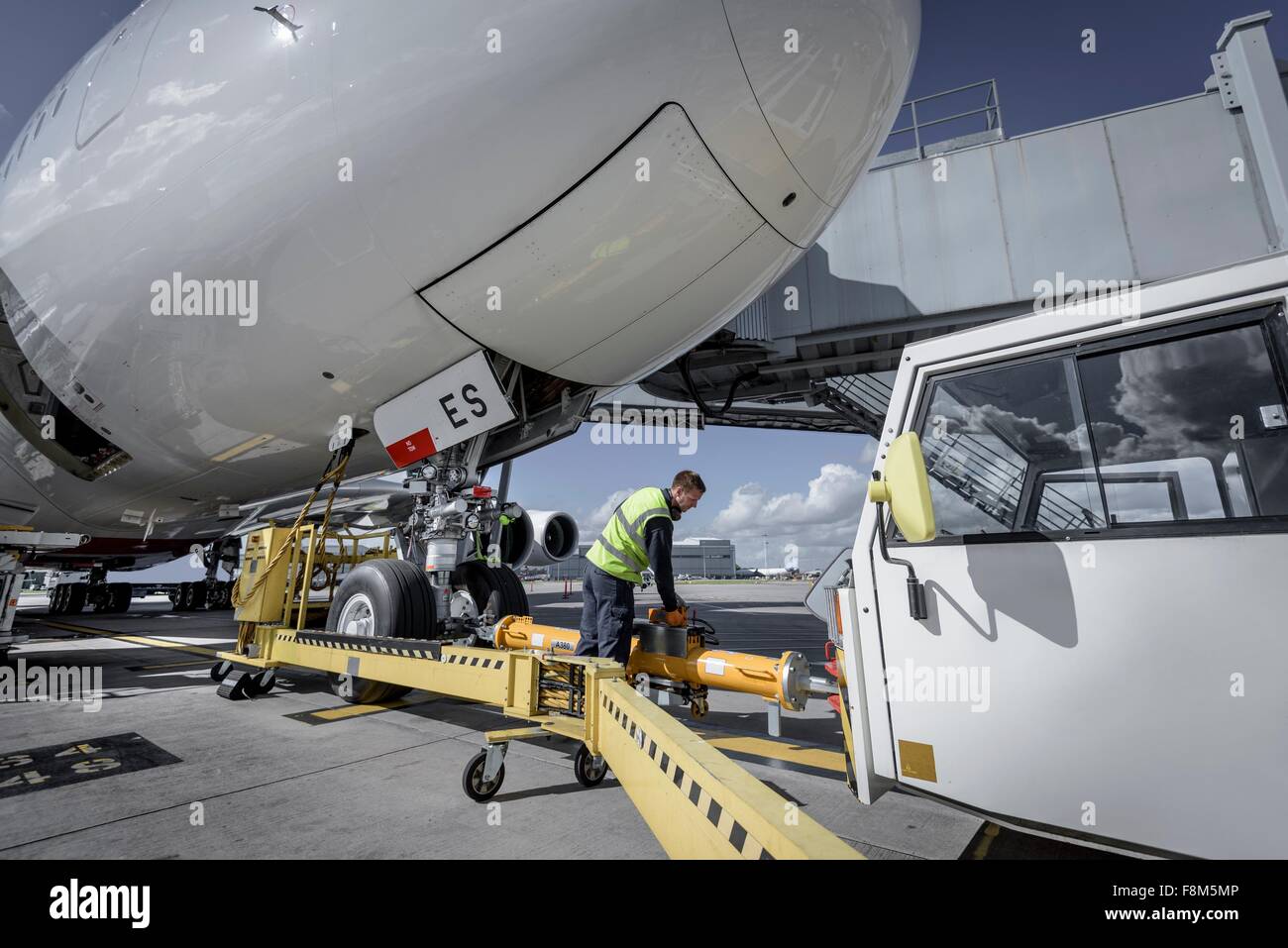 Ground crew attaching tow bar to A380 aircraft Stock Photo