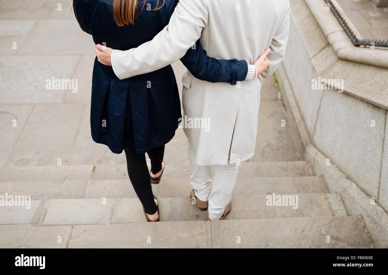 Rear view of romantic couple walking down city steps Stock Photo - Alamy