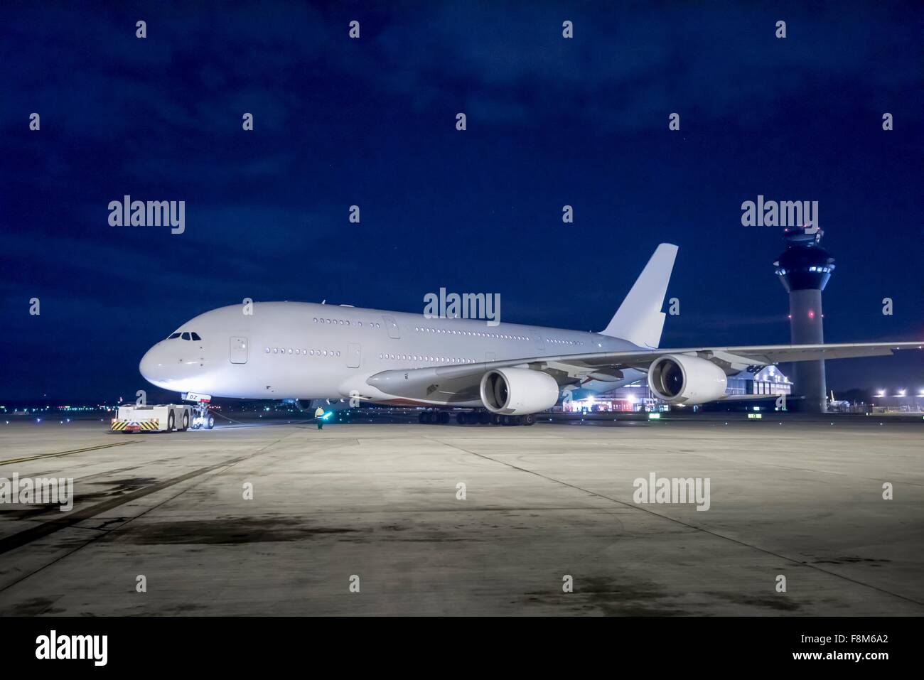 Chief engineer with A380 aircraft on runway at night Stock Photo