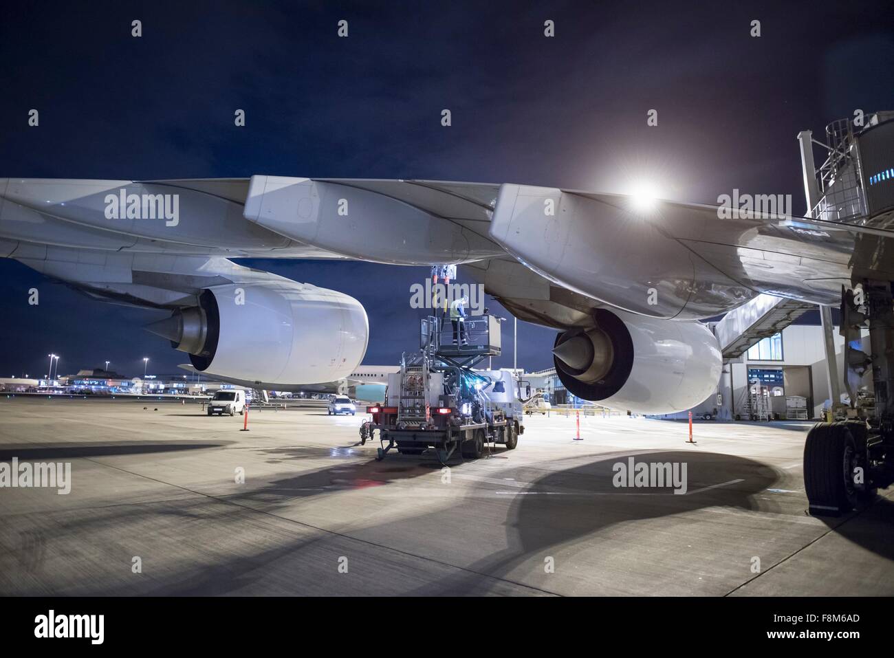Refuelling A380 aircraft on runway at night Stock Photo