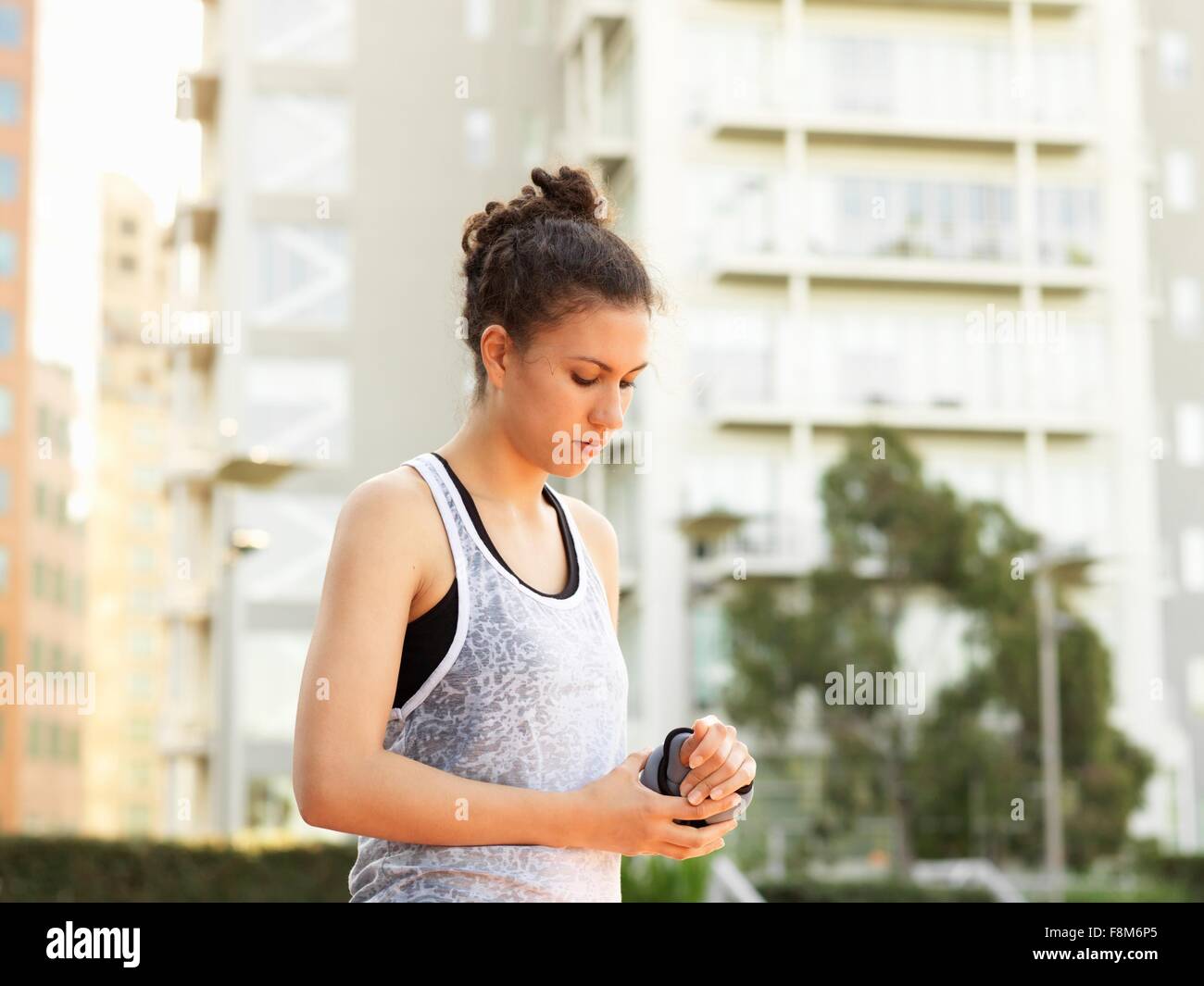 Young woman wearing wrist weight in park Stock Photo Alamy