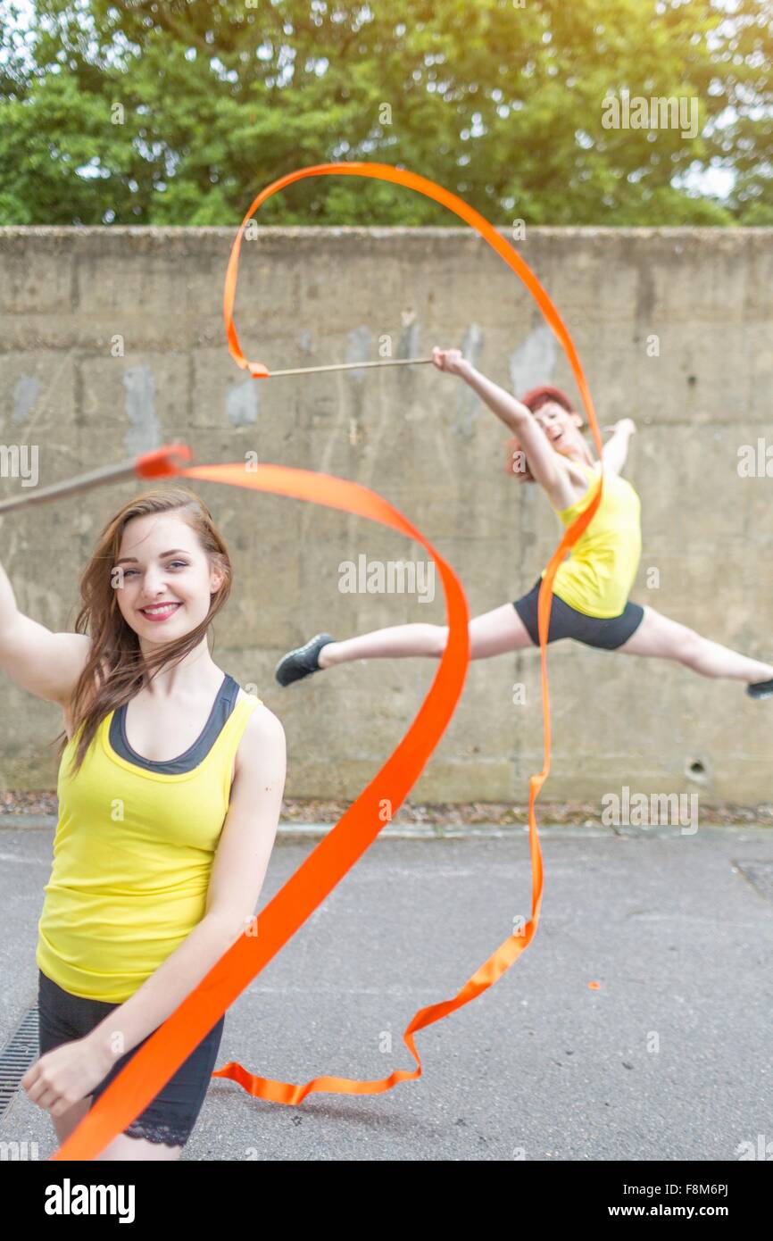 Young women practising ribbon dance on court Stock Photo Alamy