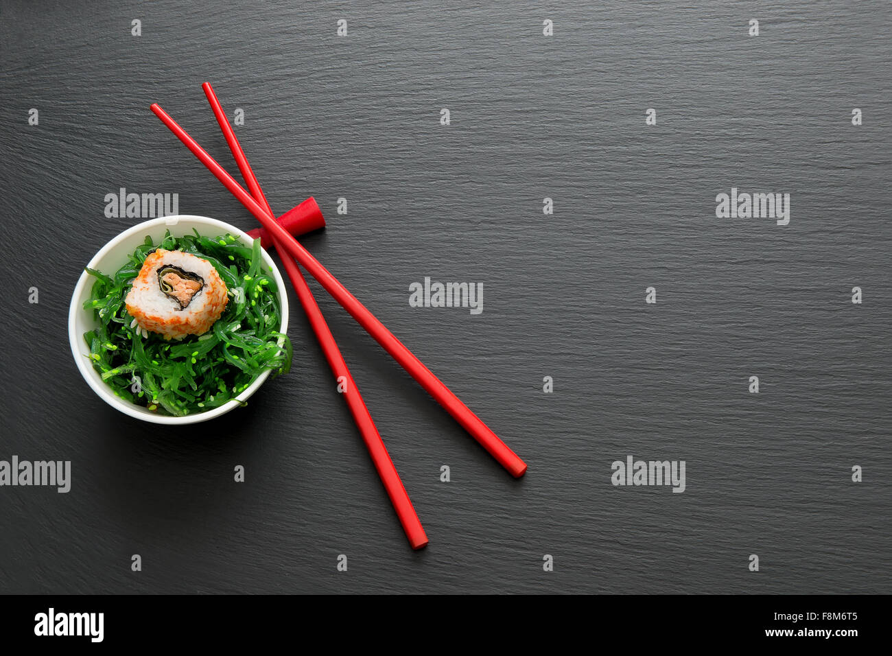 Sushi roll with seaweed on a slate table Stock Photo