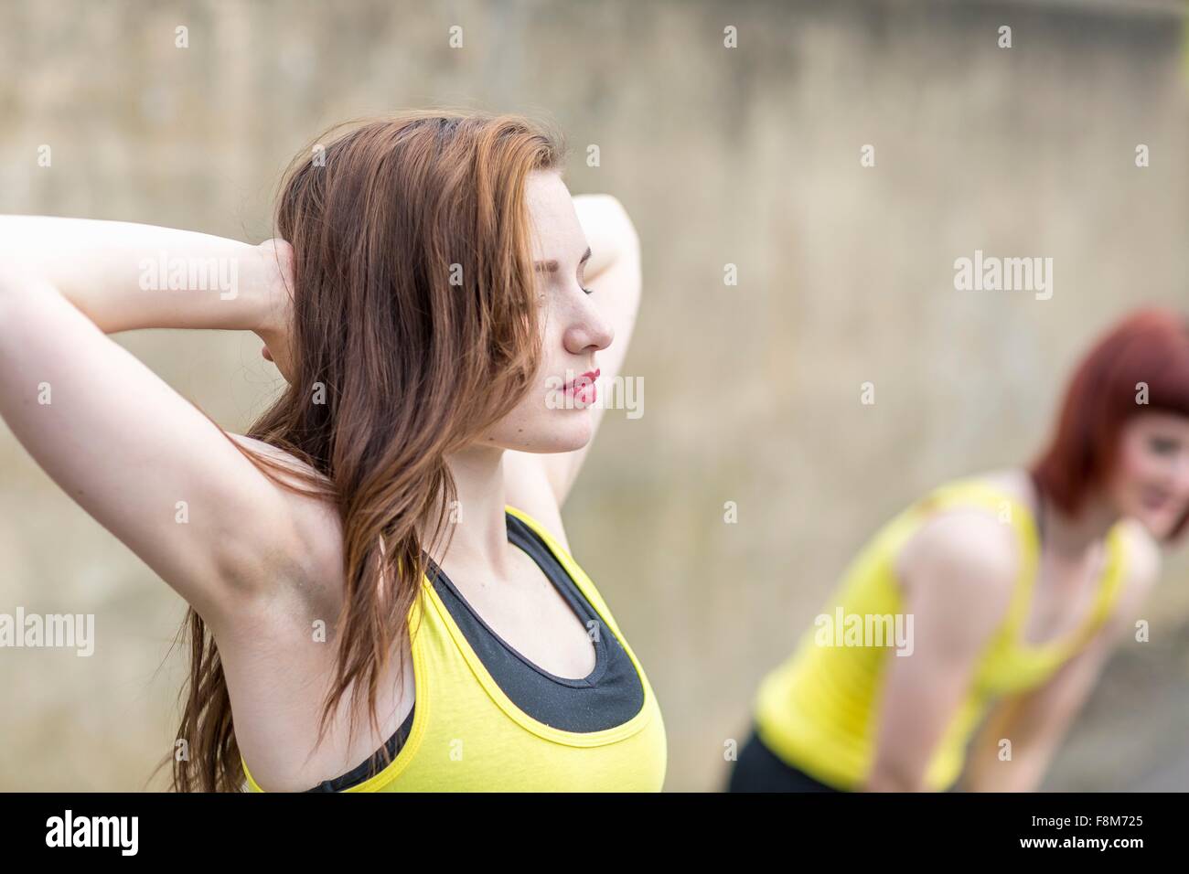Young women stretching outdoors Stock Photo