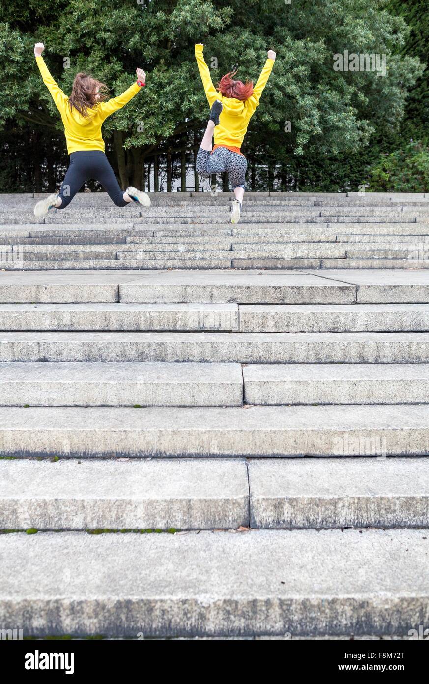 Young women jumping on steps Stock Photo